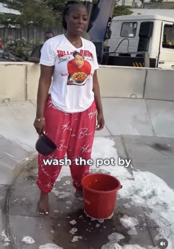 Hilda Baci inside big jollof rice pot